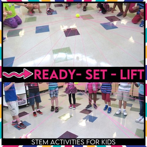 Students lift a string device as a team